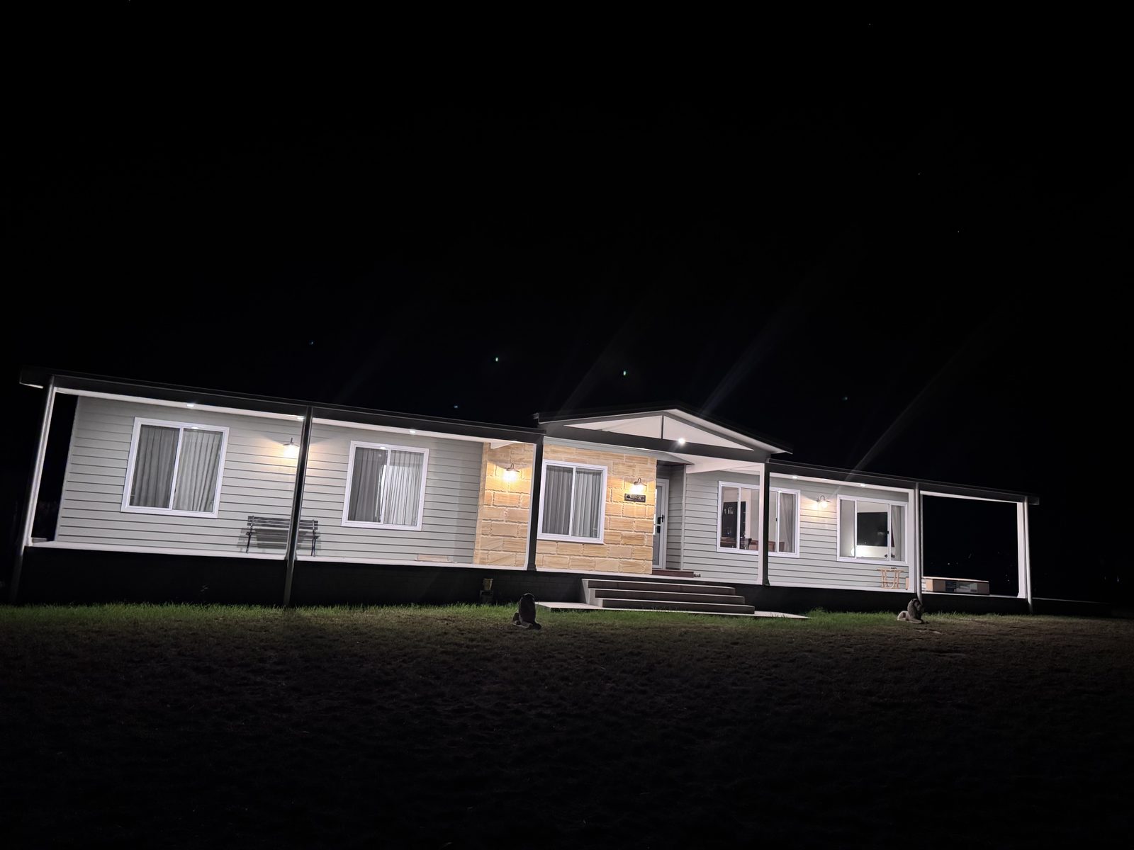 Wonga: weatherboard home lit at night